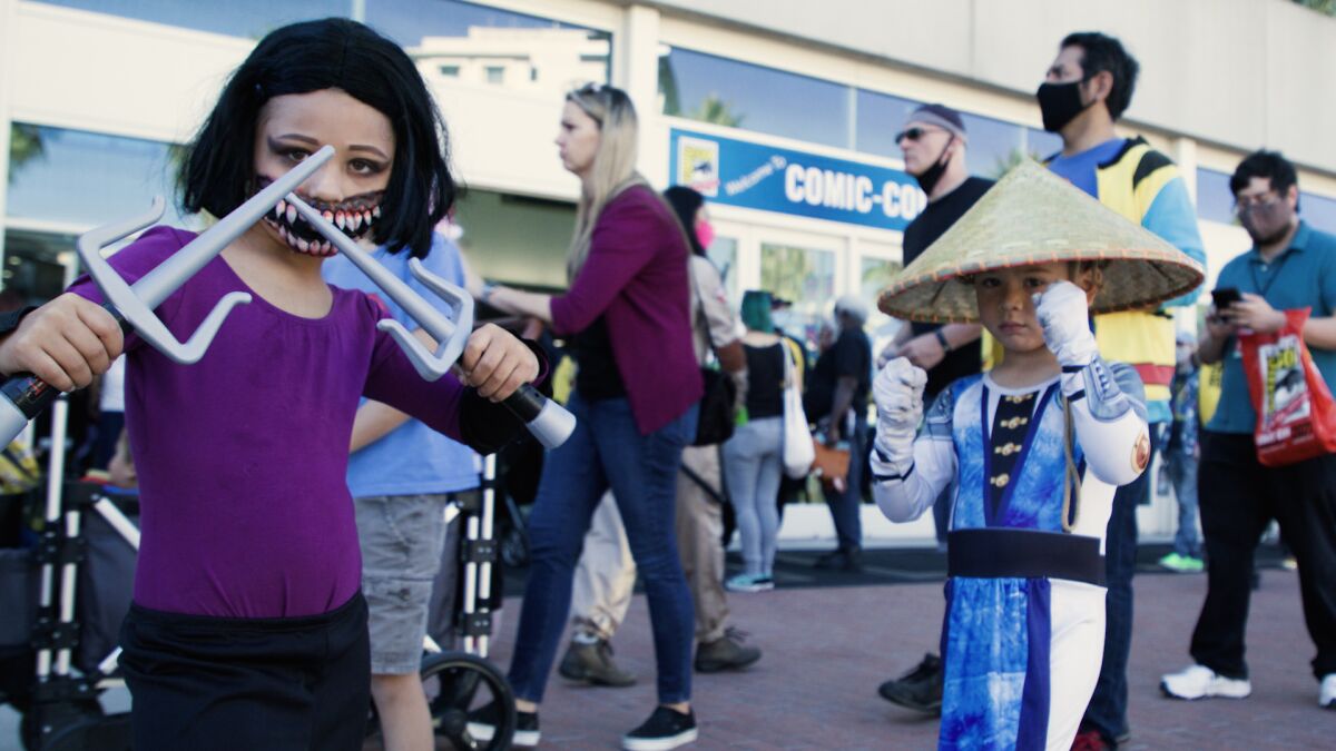 Arya and Raiden Moss, dressed as Mileena and Raiden from the Mortal Kombat series, attend Comic-Con Special Edition
