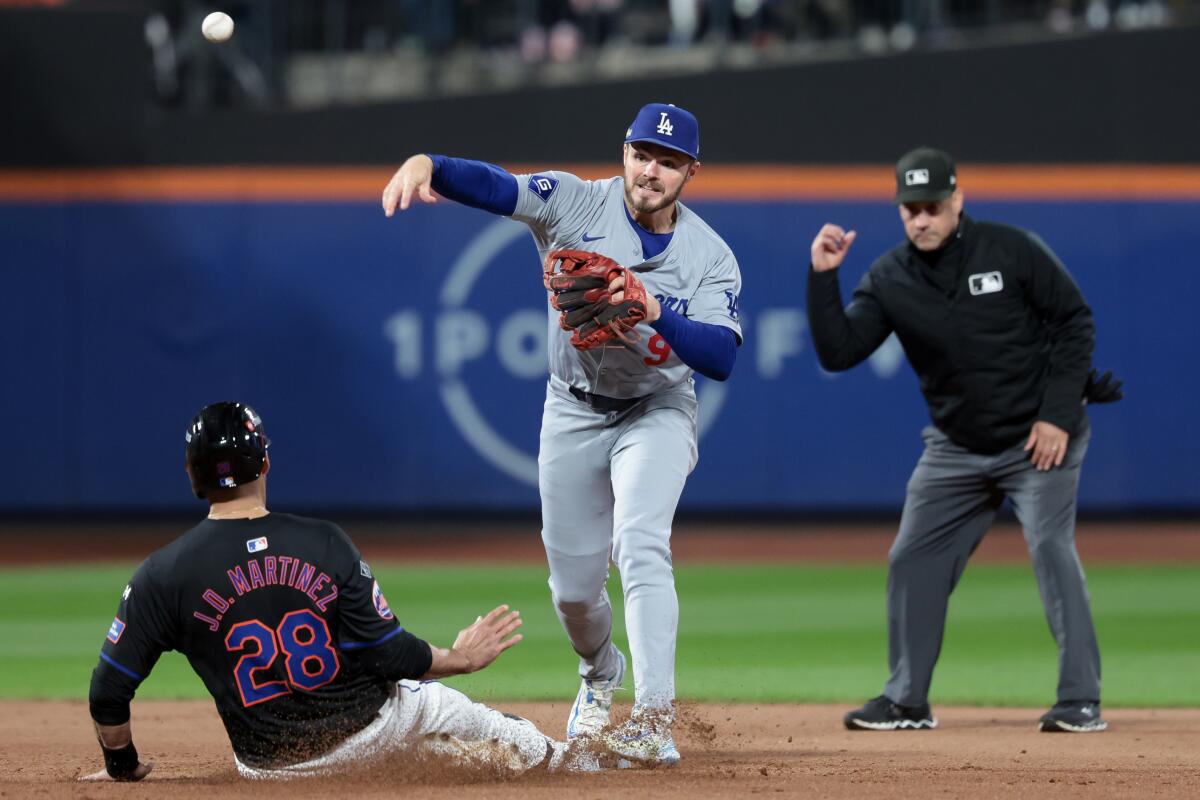 Dodgers second baseman Gavin Lux turns an inning-ending double play against the Mets.