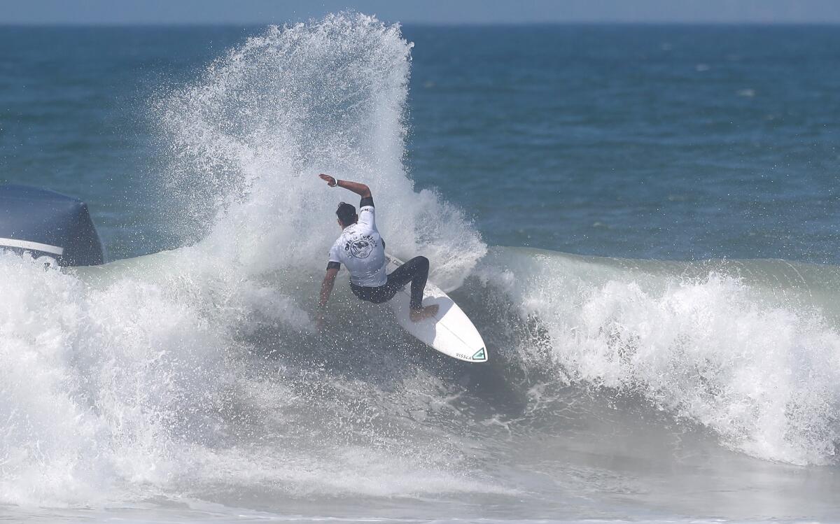 Cole Houshmand cuts back on a wave as he competes in the second round of the Vans U.S. Open of Surfing men's competition.