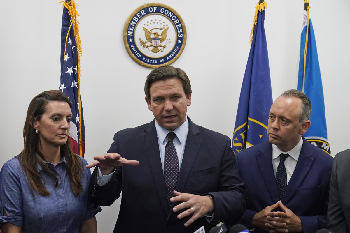 Florida Gov. Ron DeSantis, center, speaks during a news conference at the offices of Rep. Maria Elvira Salazar, R-Fla., alongside Lt. Gov. Jeanette Nunez, left, and Marcell Felipe, right, founder of the Inspire America Foundation, an organization dedicated to promoting democracy in Cuba and the Americas, Thursday, July 15, 2021, in Miami. DeSantis and other officials pressed the White House on Thursday to support efforts to preserve internet service to antigovernment protesters in Cuba, even advocating the use of giant balloons as floating Wi-Fi hotspots to allow images of dissent to stream unabated from the authoritarian nation. (AP Photo/Wilfredo Lee)