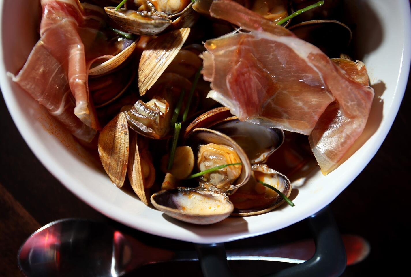 Almejes amb pernil i carxofes, made with Manila clams, serrano ham, artichokes and all i pebre, is one of the dishes at Smoke.Oil.Salt, which serves mainly modernized Catalan dishes.