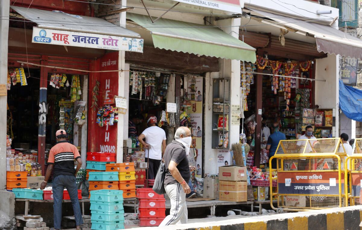Grocery shops are seen open during lockdown to prevent the spread of the coronavirus in Prayagraj, India, on Saturday.