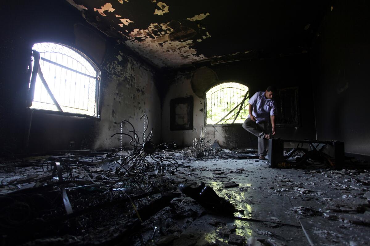 A Sept. 13, 2012, photo shows a Libyan man investigating the inside of the U.S. diplomatic mission in Benghazi, Libya, after attacks there and at a nearby CIA post killed four Americans.