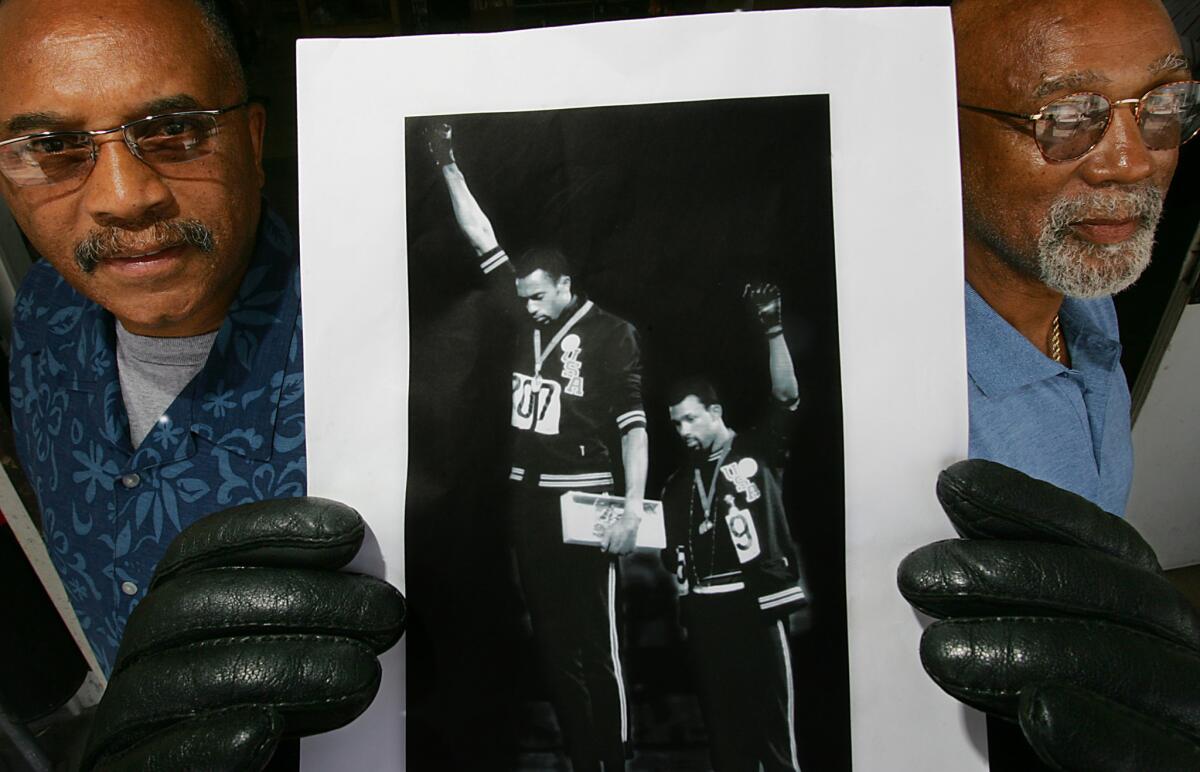 Tommie Smith, left, and John Carlos, pictured in 2005, are forever linked by their gesture.