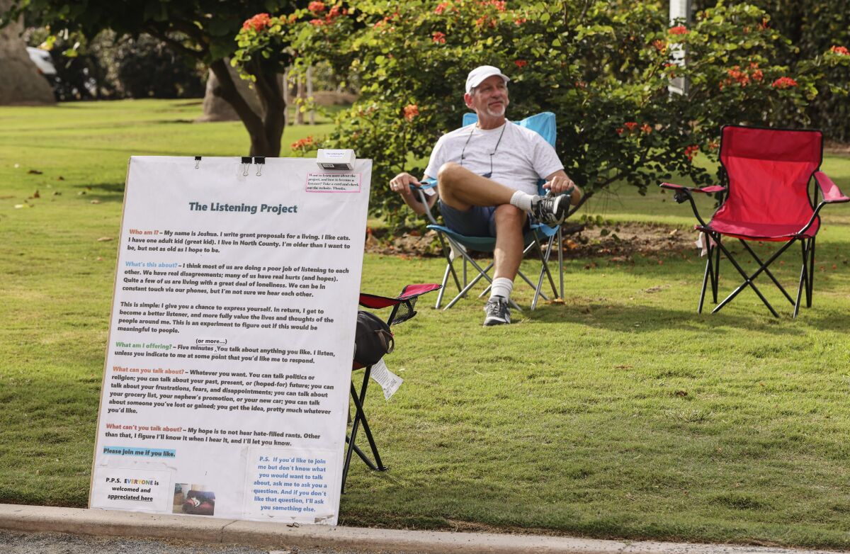 Joshua Lazerson sits in his chair and waits for passers-by at Swami's Seaside Park in Encinitas.  