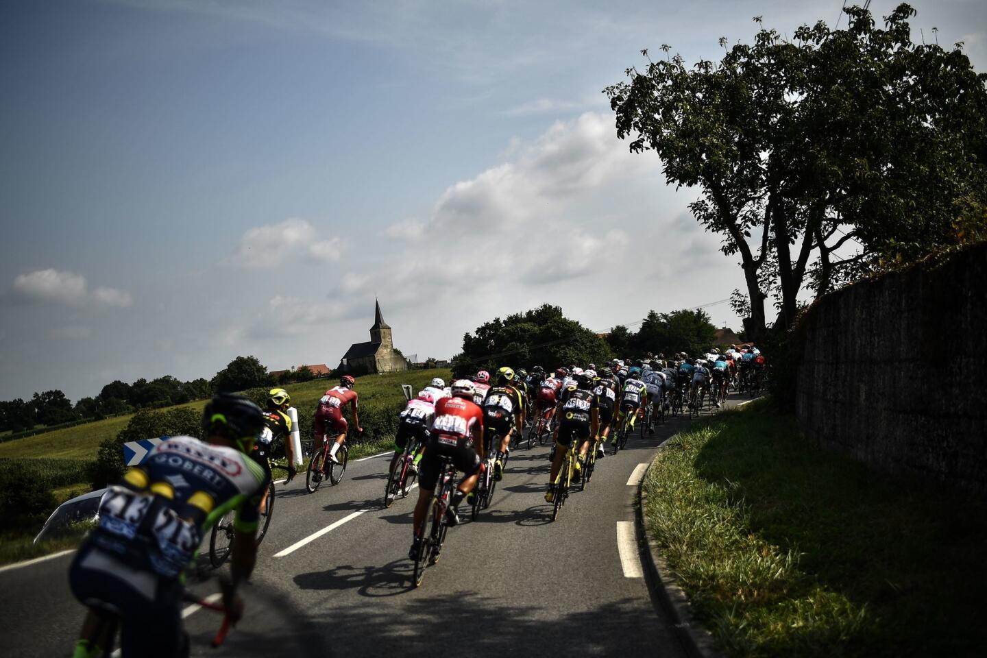 The pack rides through a bend during the 18th stage of the 105th edition of the Tour de France cycling race on July 26, 2018 between Trie-sur-Baise and Pau in southwestern France.