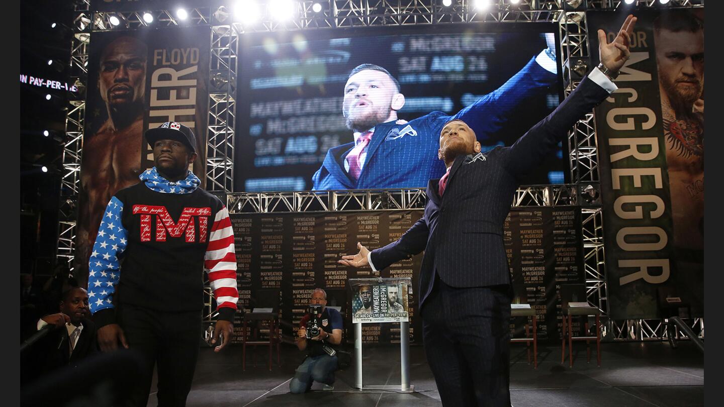 Floyd “Money” Mayweather Jr., left, and UFC champion “The Notorious” Conor McGregor at Staples Center on Tuesday. Mayweather and McGregor embarked on a four-city international press tour.