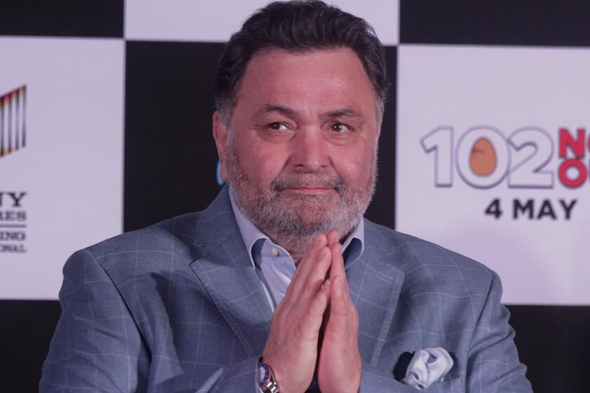 FILE- In this April 19, 2018 file photo, Bollywood actor Rishi Kapoor greets media as he arrives for the song launch of film '102 Not Out' in Mumbai, India. Rishi Kapoor, a top Indian actor and a scion of Bollywood’s most famous Kapoor family, has died after a battle with cancer. He was 67.(AP Photo/Rafiq Maqbool, File)