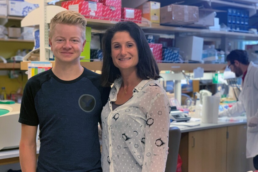 This September 2019 photo provided by UC San Diego shows Stephanie Cherqui and patient Jordan Janz in her research lab in La Jolla, Calif. Jordan Janz knew his gamble on an experimental gene therapy for his rare disease might be paying off when he returned to work and a friend sniffed him. “He said, ‘you have a normal smell, you smell good,’” Janz recalled. “And I’m like, ‘that’s probably the nicest thing you’ve ever said.’” The 22-year-old Canadian man's previous treatment required 40 to 60 pills a day and left him smelling like rotten eggs or stinky cheese (UC San Diego via AP)