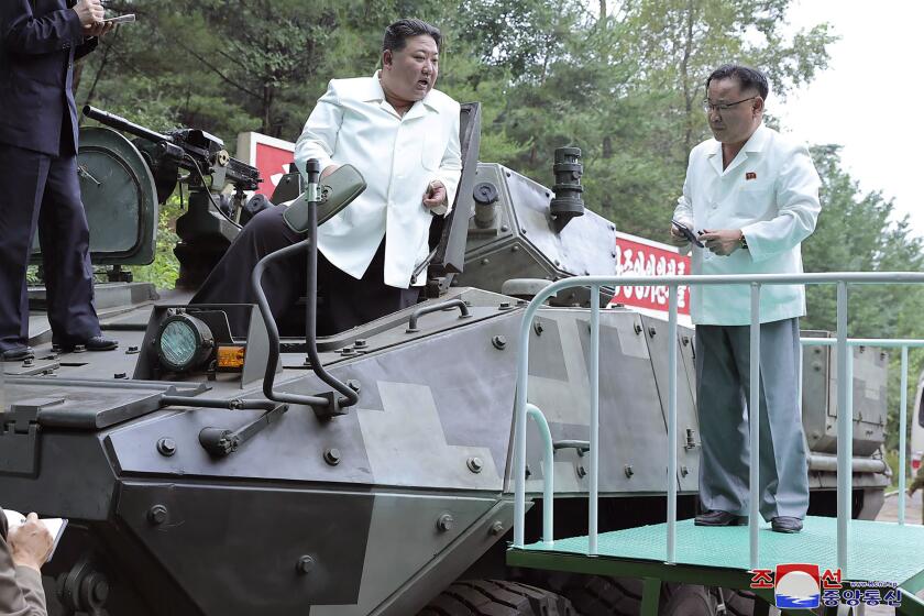 In this undated photo provided on Monday, Aug. 14, 2023, by the North Korean government, North Korean leader Kim Jong Un, center, rides on an armored vehicle during his Aug. 11-12 visit to a military factory in North Korea. Independent journalists were not given access to cover the event depicted in this image distributed by the North Korean government. The content of this image is as provided and cannot be independently verified. Korean language watermark on image as provided by source reads: "KCNA" which is the abbreviation for Korean Central News Agency. (Korean Central News Agency/Korea News Service via AP)