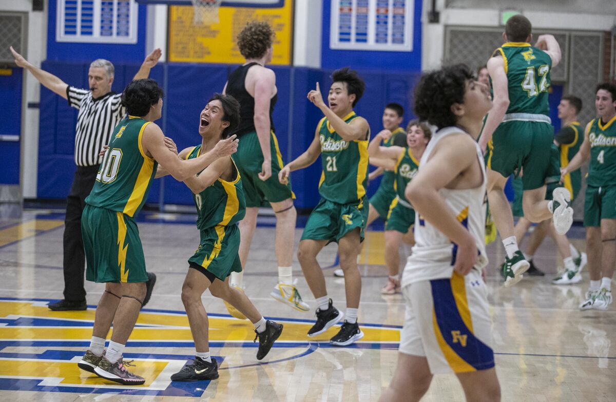 The Edison High boys' basketball team celebrates after beating Fountain Valley in a Surf League game on Thursday.