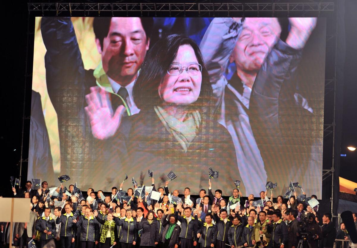 Taiwan President-elect Tsai Ing-wen appears on a screen as she celebrates her victory alongside party officials in Taipei, Taiwan.