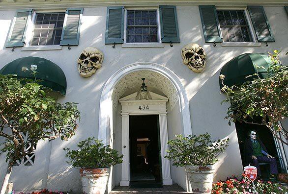 A pair of skeleton heads offers up a spooky greeting at director Rich Corrells French Tudor home in historic Hancock Park. Every Halloween, the horror movie buff turns his home into a haunted mansion, with decorations that include his 1,900-plus collection of horror film memorabilia. Watch video: