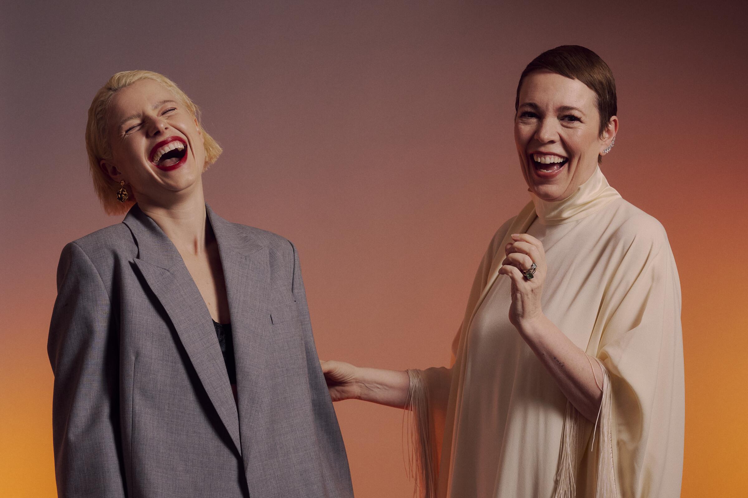 Two women laugh together.