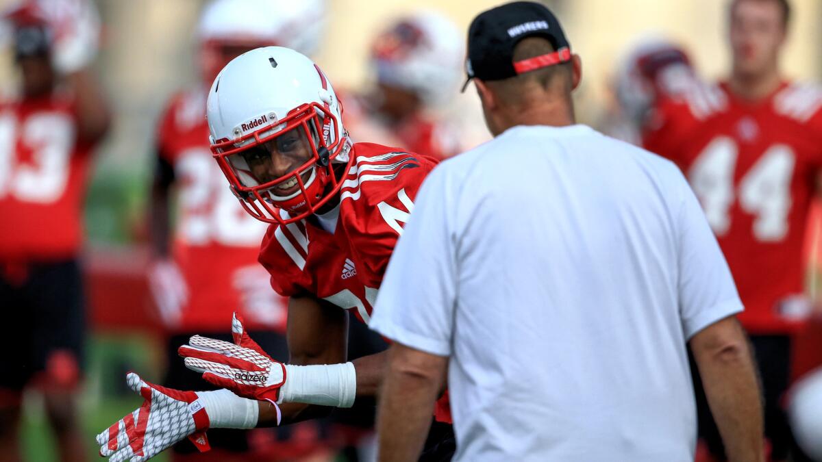 Nebraska cornerback Daniel Davie reacts as Coach Mike Riley interacts with him during a practice on Aug. 6 in Lincoln.