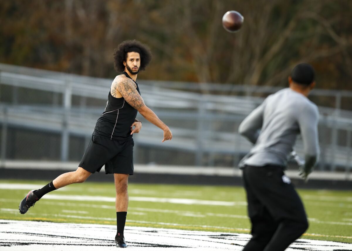 Colin Kaepernick throws a pass during a workout session.