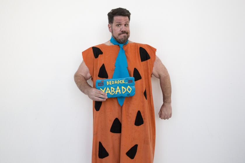Sebastian Sanzberro, 49, of Corona, wears a homemade Fred Flintstone costume made by his wife.
