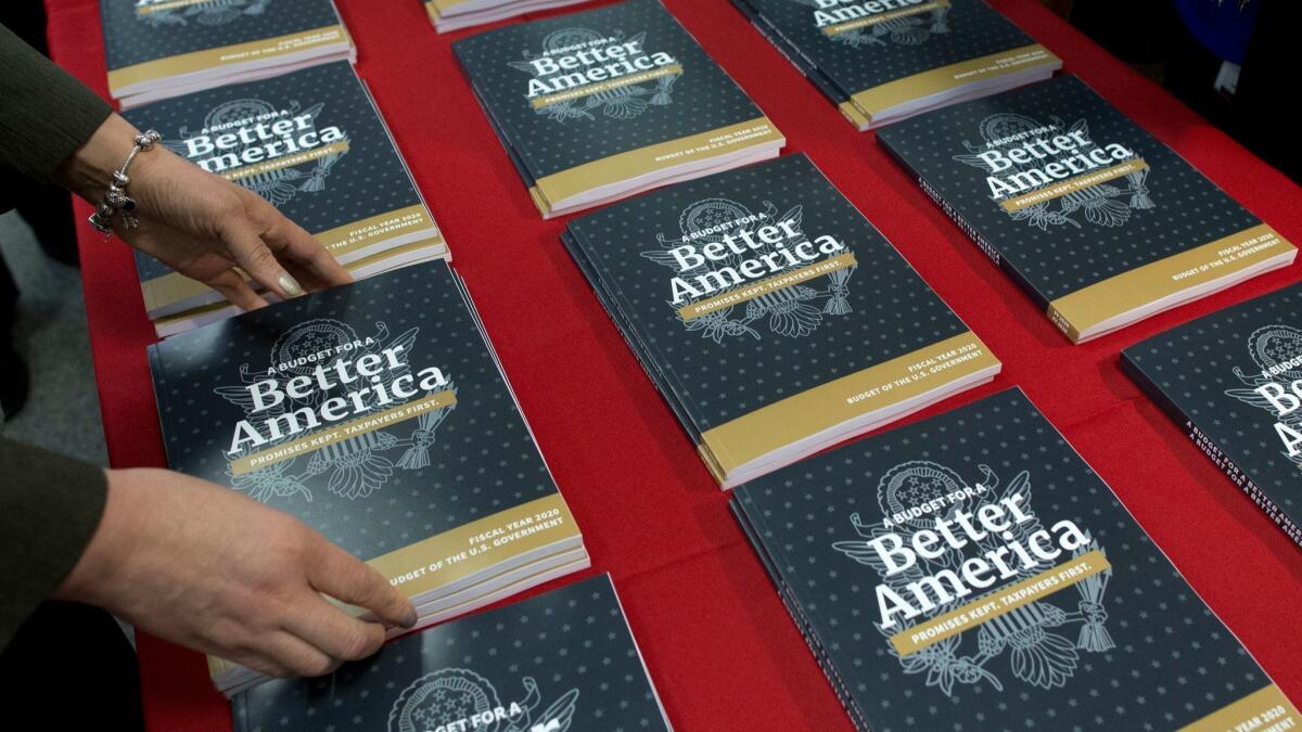 Government Publishing Office employees lay out copies of President Trump's budget for the fiscal year 2020 in Washington on March 11.