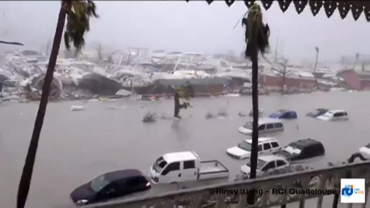 A handout grab image made from a video released on Sept. 6, 2017 by RCI Guadeloupe shows flooded streets and damage on the French overseas island of Saint-Martin