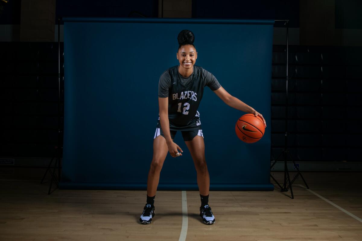 Sierra Canyon senior Juju Watkins dribbles a basketball during a photo shoot at media day.