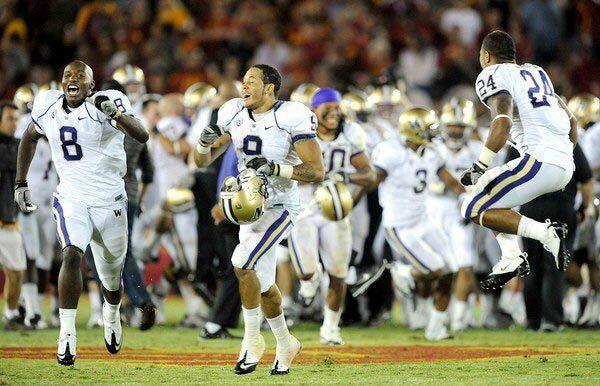 Washington players celebrate after a last-second field goal gave the Huskies a 32-31 victory over USC at the Coliseum on Saturday night.