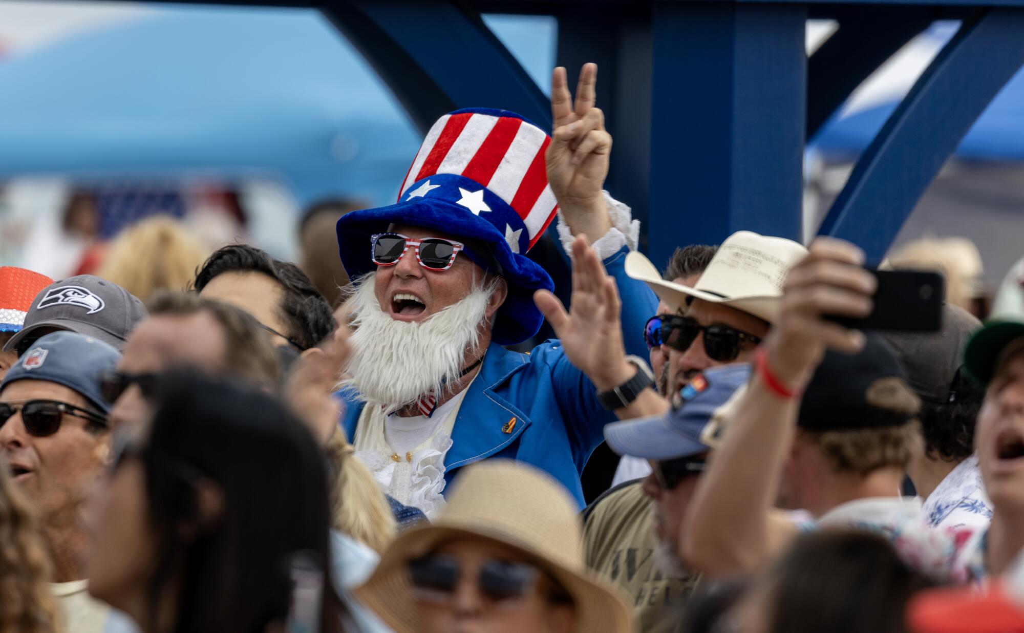 A man dressed as Uncle Sam in a crowd of people
