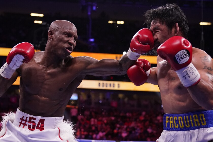 Yordenis Ugas hits Manny Pacquiao during a welterweight championship boxing match
