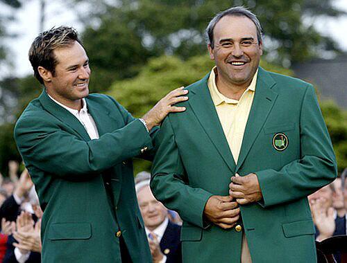 Trevor Immelman, the 2008 Masters champion, helps 2009 winner Angel Cabrera put on the ceremonial green jacket following his sudden-death playoff victory Sunday at Augusta National.