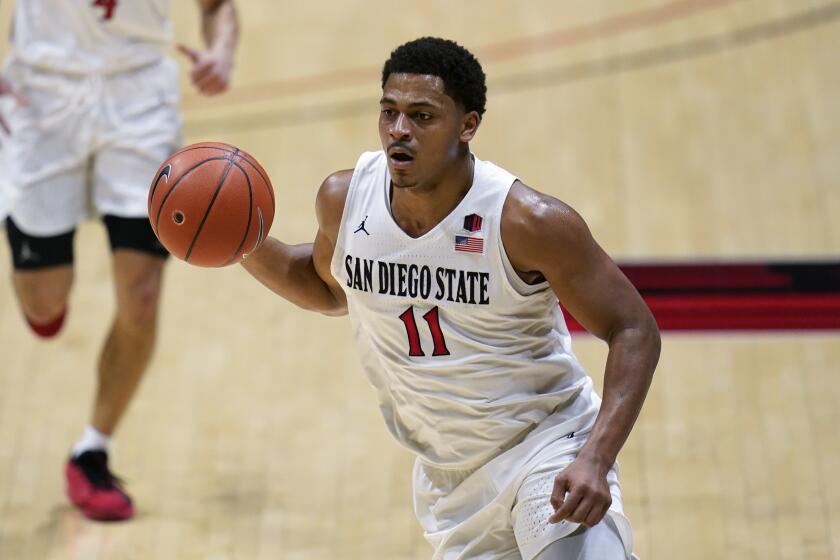 San Diego State forward Matt Mitchell (11) controls the ball during the first half of an NCAA.