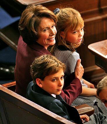 Rep. Nancy Pelosi is kept company by her grandchildren as the vote is taken for the new Speaker of the House.