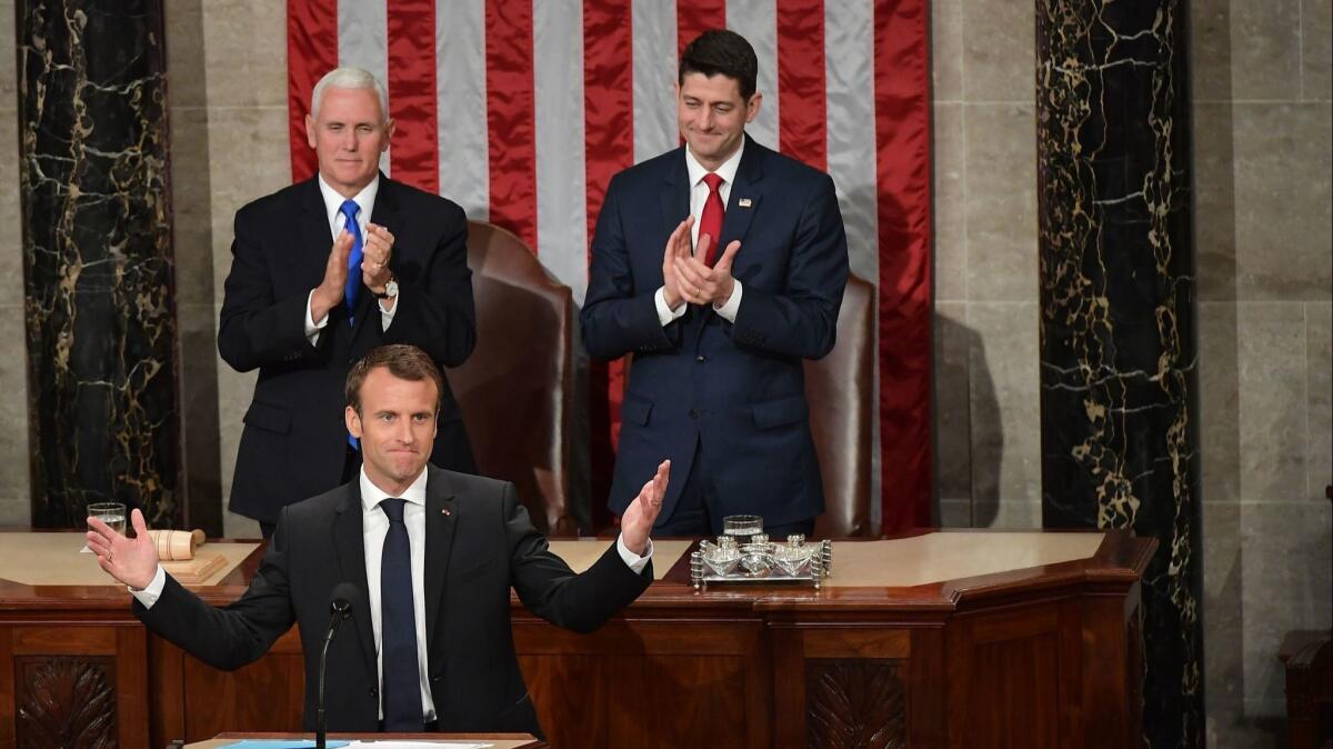 Vice President Mike Pence, rear left, and House Speaker Paul D. Ryan (R-Wis.), rear right, applaud after French President Emmanuel Macron addressed a joint meeting of Congress.