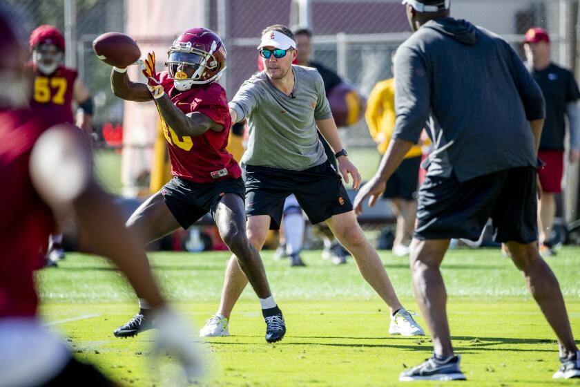 LOS ANGELES, CA - MARCH 22, 2022: First year USC football coach Lincoln Riley interacts with wide receiver Kyron Ware-Hudson (10) from Mater Dei during spring practice at USC on March 22, 2022 in Los Angeles, California.(Gina Ferazzi / Los Angeles Times)