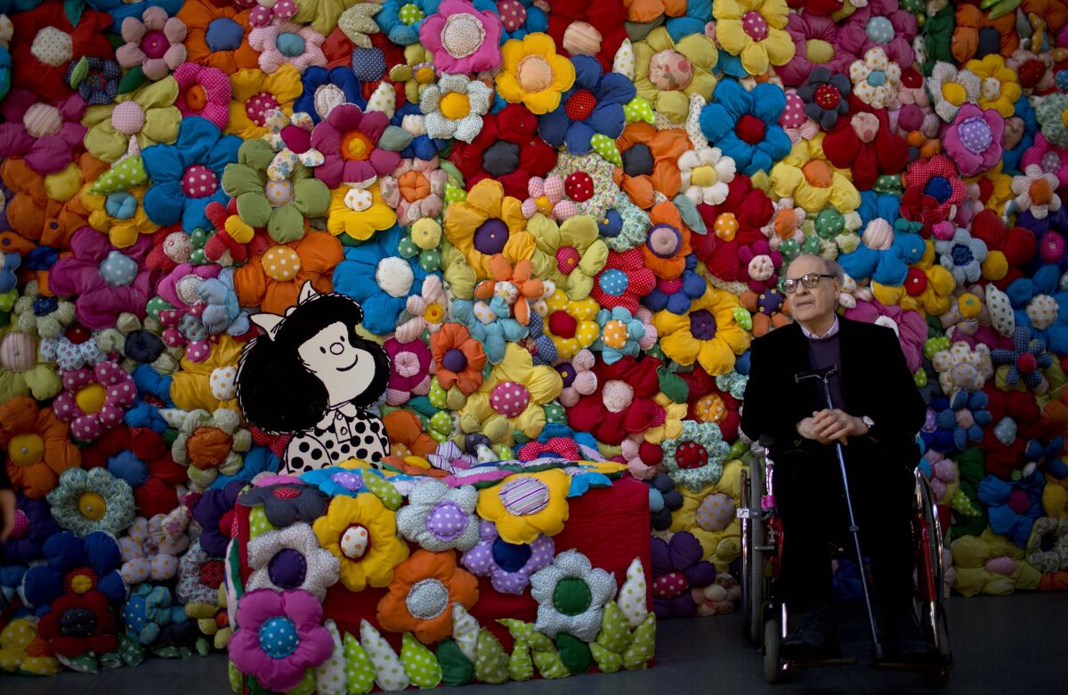 Argentine cartoonist Joaquin Salvador Lavado, better known as "Quino," poses next to his character Mafalda in 2014.