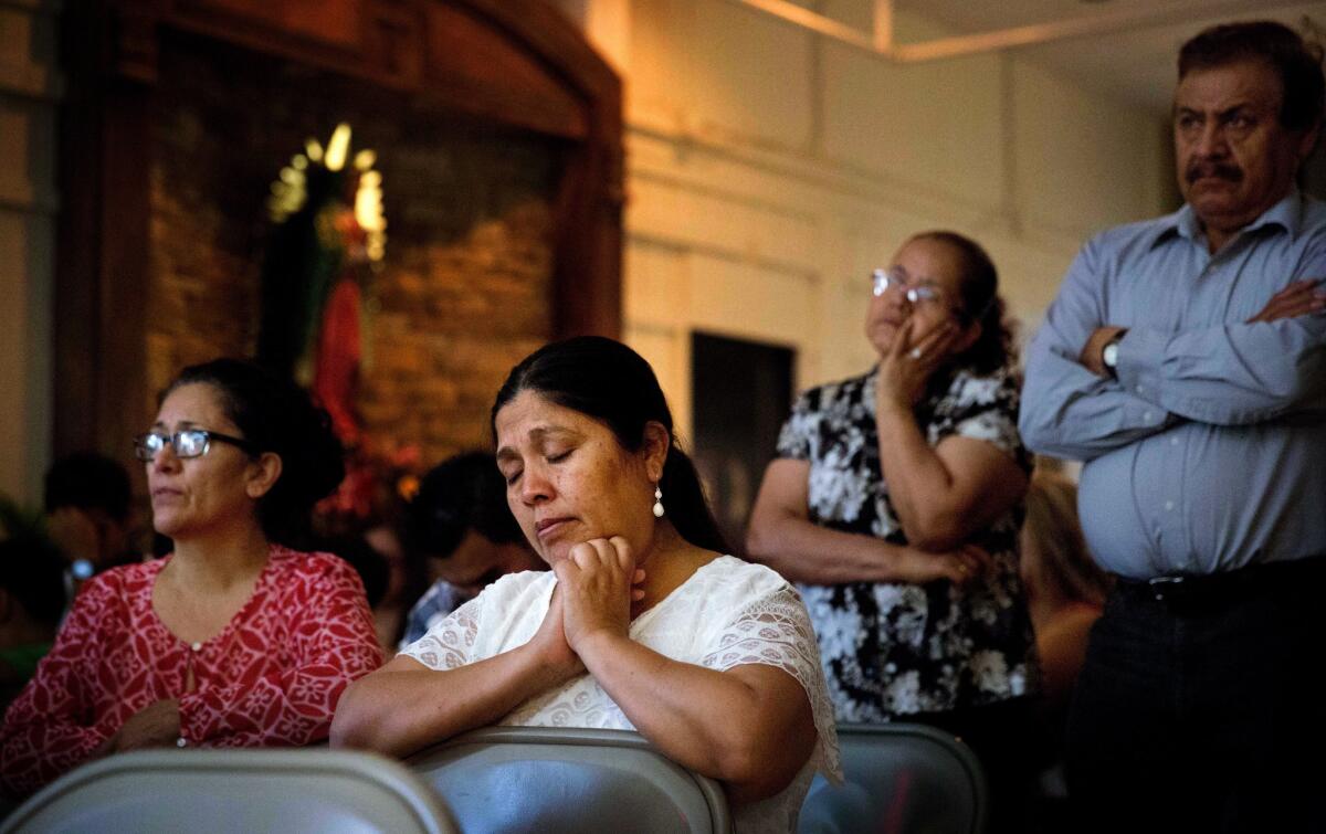 A parishioner prays during Mass at St. John Paul II Pastoral Center in Gainesville, Ga., on Sunday, Aug. 9, 2015.