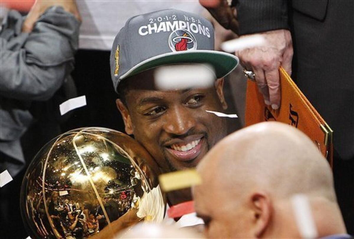Dwyane Wade with his two NBA Championship Trophies Game 5 of the