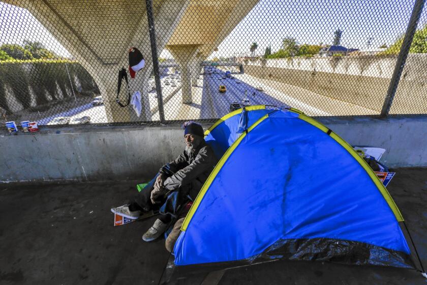 Tony Dennis, 58, is among about 26,000 homeless people in L.A. He lives in a tent on the 42nd Street bridge over the 110 Freeway.