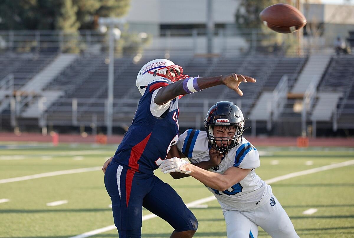 Washington Prep quarterback Sesame Mixon is hit by Jordan defensive end Jaime Garzon just after releasing the ball.