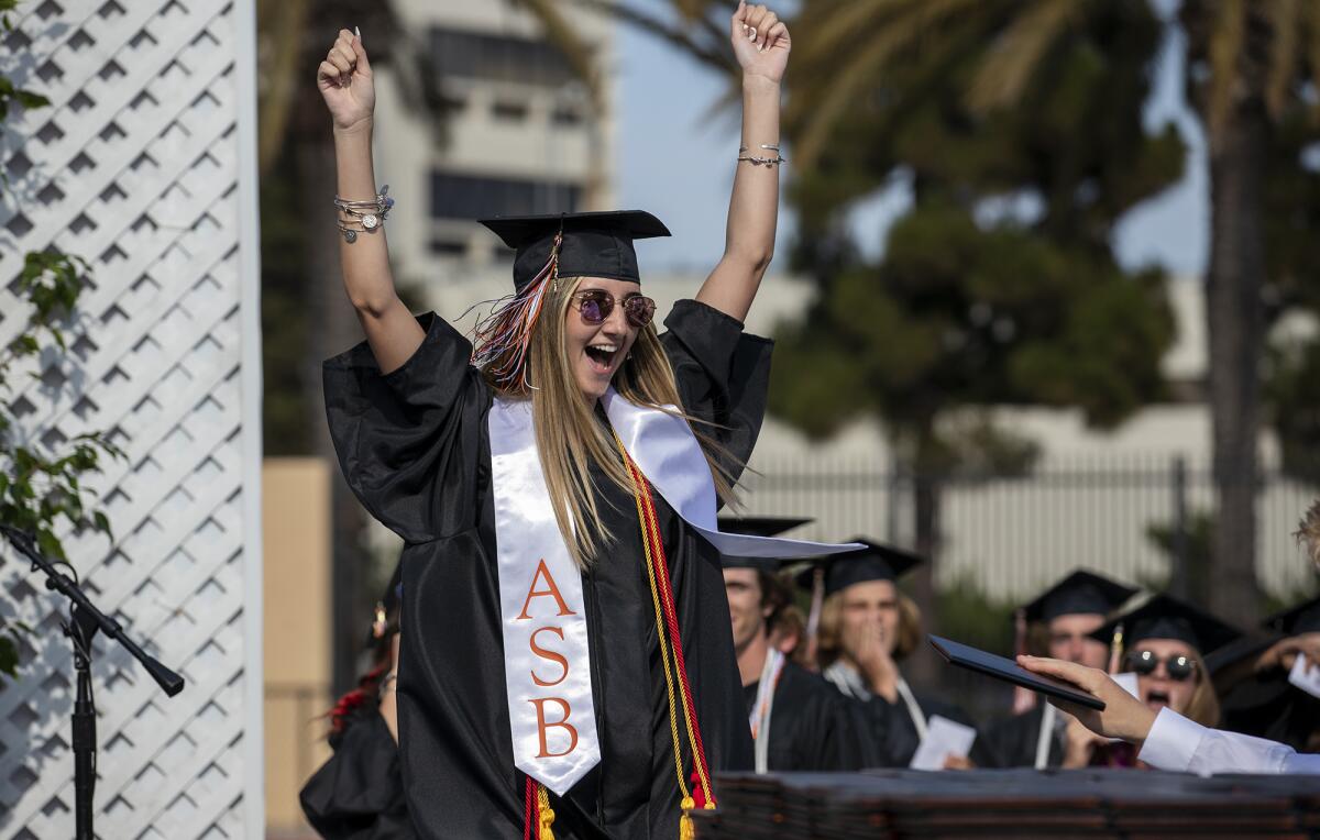 A graduate celebrates during the Huntington Beach High School 2021 commencement ceremony on Tuesday, June 15.