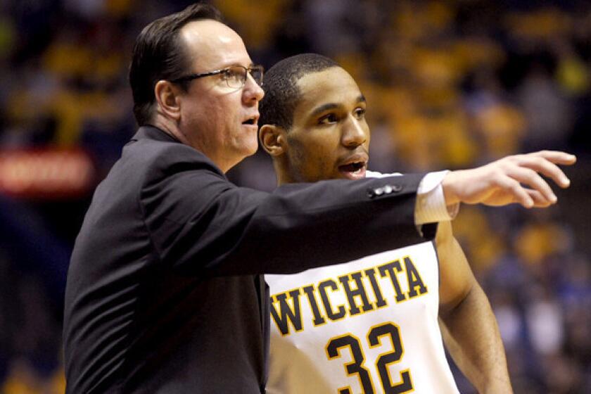 Wichita State Coach Gregg Marshall discusses strategy with Tekele Cotton against Indiana State in the Missouri Valley Conference tournament championship game.