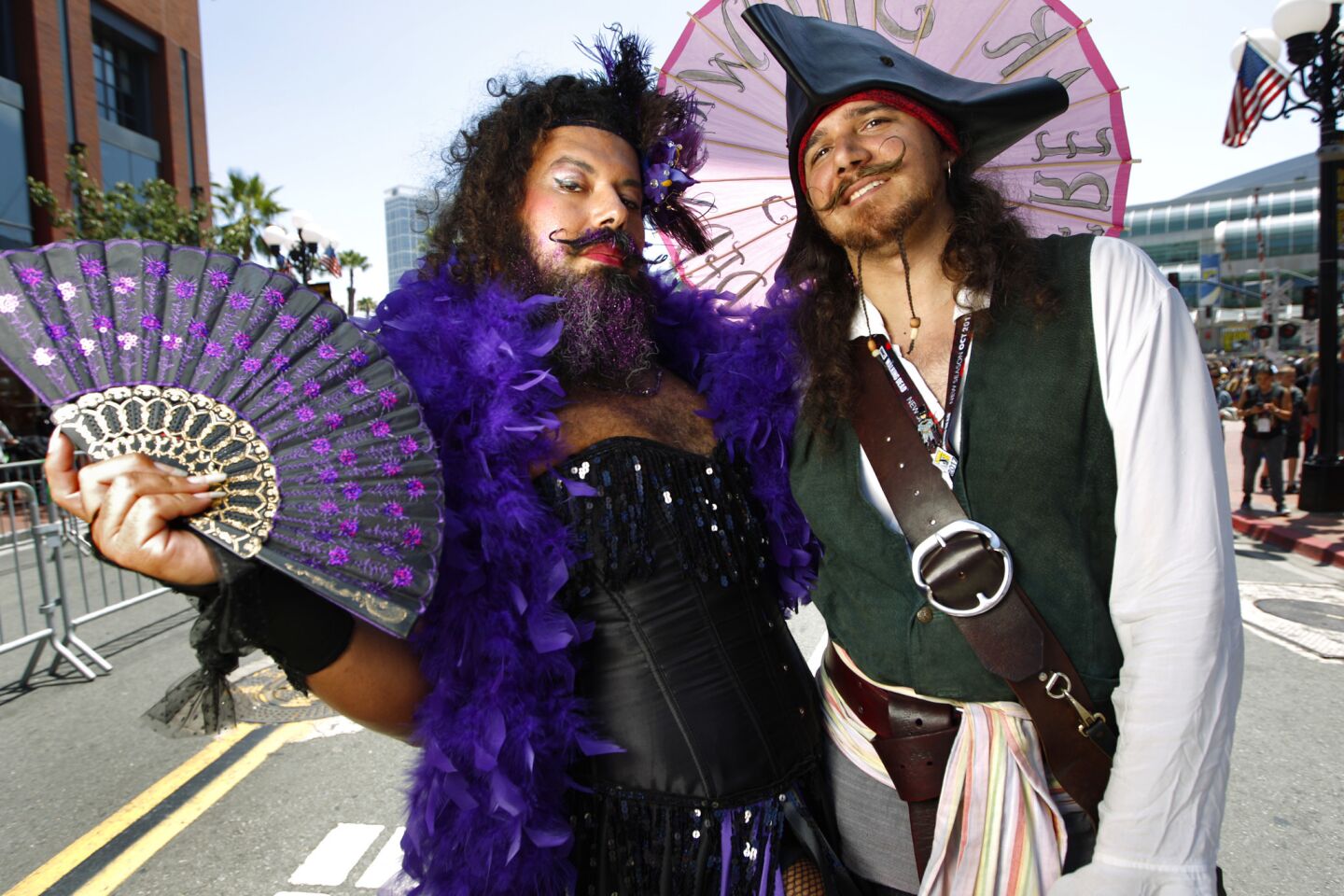 Alberto Hurtado is dressed as Iris the Bearded Lady Freakshow and Ron Majji is Capt. Jack Sparrow at Comic-Con International in San Diego on Thursday.