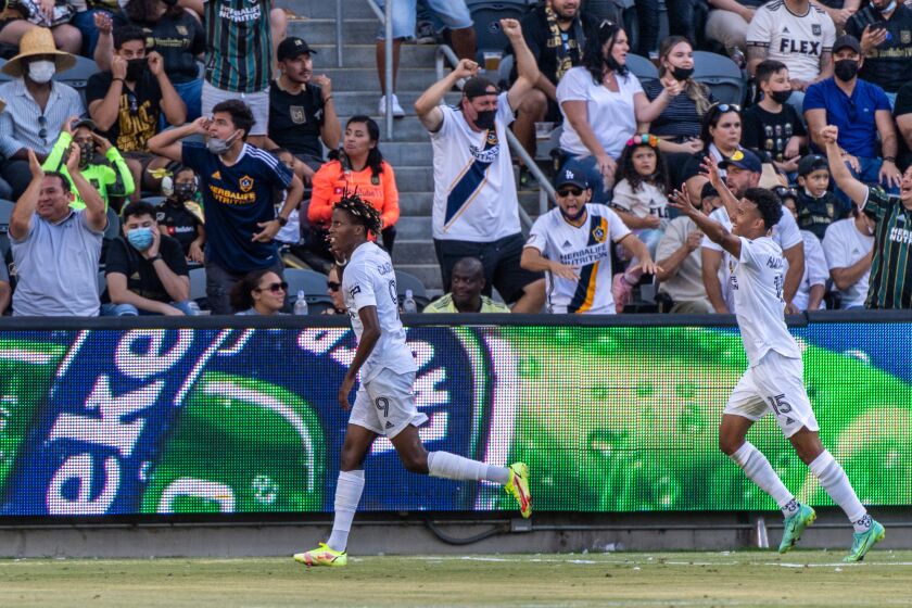 The Galaxy's Kévin Cabral, left, celebrates his game-tying goal against LAFC at Banc of California Stadium on Aug. 28, 2021.