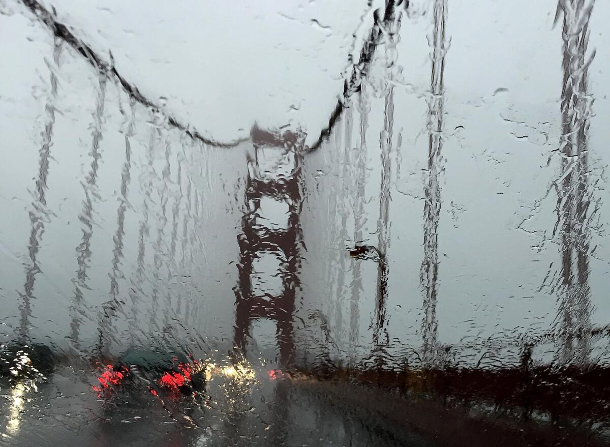 San Francisco's Golden Gate Bridge is seen through a rain-covered windshield in December. It didn't rain at all in San Francisco in January, but rain is hitting the city Friday, with heavier downpours drenching other parts of Northern California.