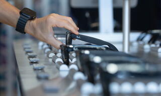 A customer grasping a pair of smartglasses on display