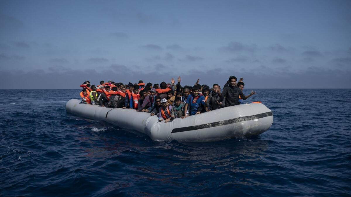 Refugees and migrants wait off the Libyan coast to be rescued by the Spanish group Proactiva Open Arms on Sunday after an attempt to reach Europe on an overcrowded boat.