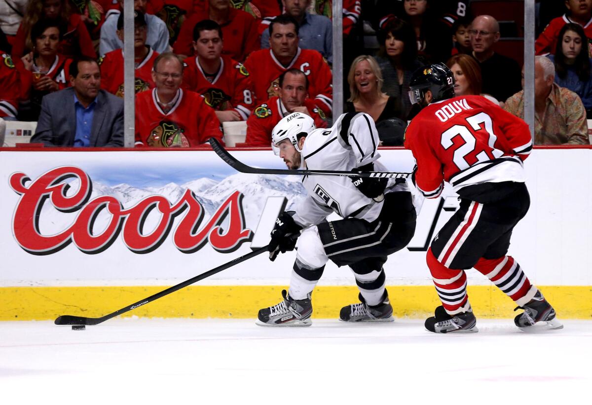 Kings' Drew Doughty, left, carries the puck past the Blackhawks' Johnny Oduya, who is usually a second-unit defenseman on the penalty kill.