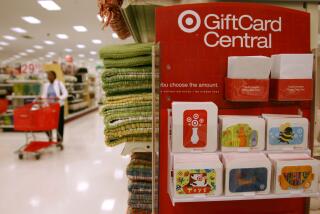 A lone shopper makes her way down an aisle behind a shopping cart past a display for gift cards in the Super Target in the east Denver suburb of Glendale, Colo., on Tuesday, May 16, 2006. Target announced its quarterly earnings on Tuesday. (AP Photo/David Zalubowski)