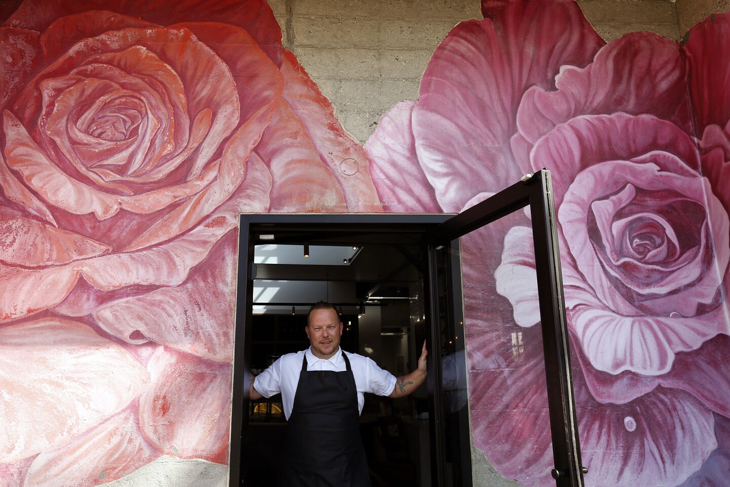 Chef Jason Neroni stands in the main doorway to the Rose Cafe in Venice.
