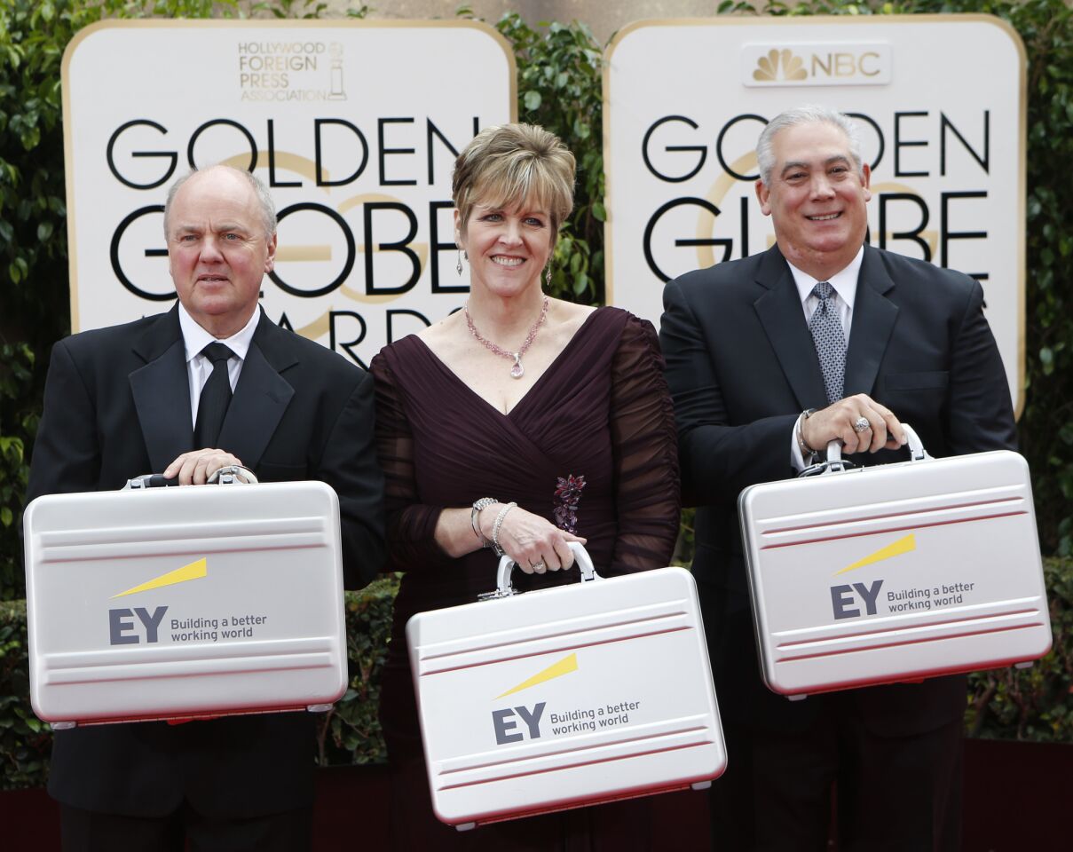 Ernst & Young couriers deliver the envelopes containing the winners to the 73rd Golden Globes at the Beverly Hilton Hotel.