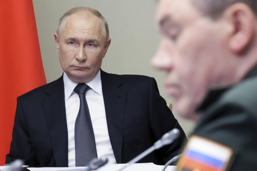 Russian President Vladimir Putin, left, leads the meeting with top security and defence officials dedicated to the situation in Kursk and Belgorod border regions, at Novo-Ogaryovo state residence outside of Moscow, Russia, Monday, Aug. 12, 2024. (Gavriil Grigorov, Sputnik, Kremlin Pool Photo via AP)