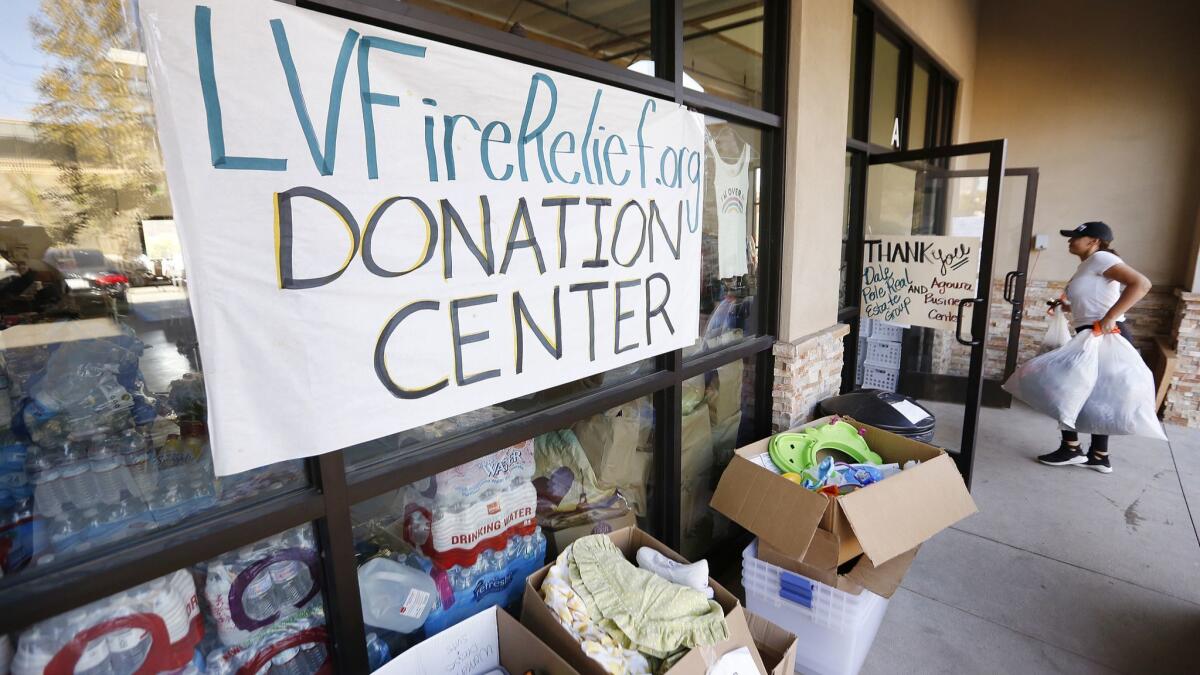 Richelle Alva, 28, from Thousands Oaks, delivers items to the Las Virgenes Fire Relief Center in Agoura Hills to help people who have lost their homes in the Woolsey Fire.